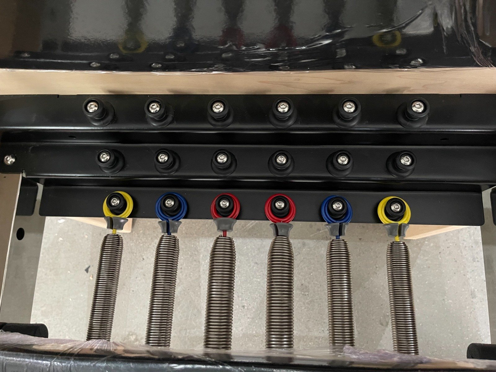 Close-up of Pilates Reformer springs, showing coil design and hook ends