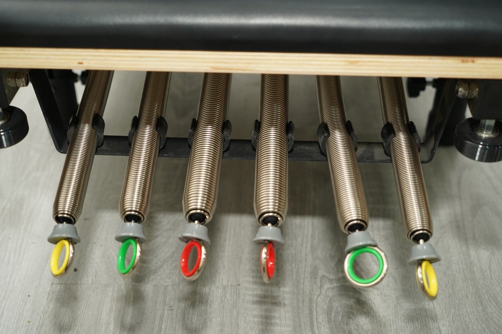 Close-up of Pilates Reformer springs, the resistance component that wears out fastest